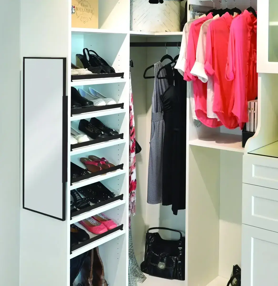 Custom walk-in closet with angled shoe display shelving and full-length mirror